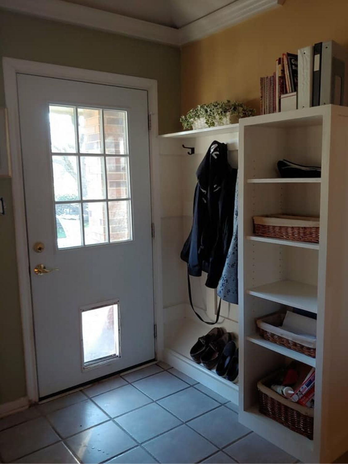 Custom mudroom entryway with built-in shelving and coat storage